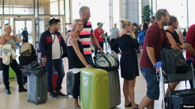 Tourists wait in line to try to catch flights home at the airport in Sharm el-Sheikh after finishing their holidays in the Red Sea resort.