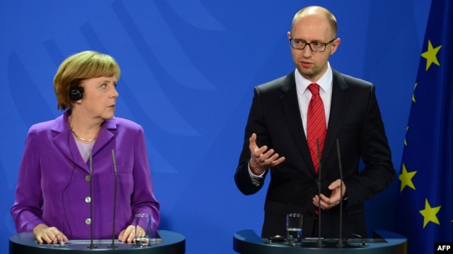 German Chancellor Angela Merkel (left) listens to Ukraine's Prime Minister Arseniy Yatsenyuk during a joint press conference after talks in Berlin on May 28.