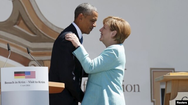 U.S. President Barack Obama (left) and German Chancellor Angela Merkel embrace after delivering remarks in the Bavarian village of Krun on June 7. 