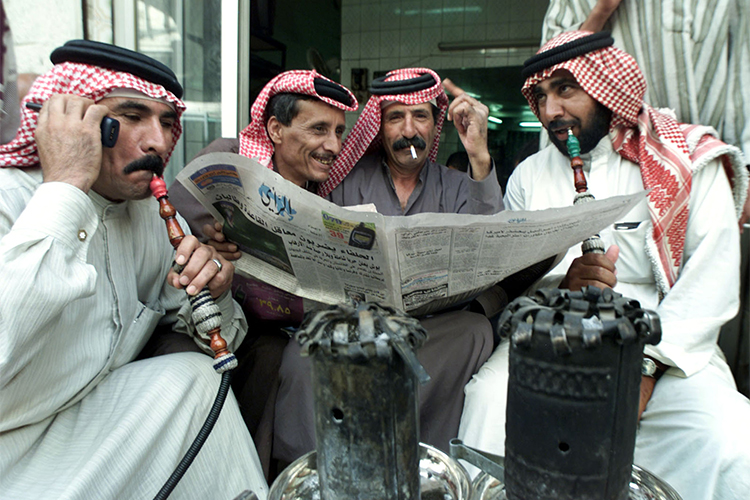 In this 2001 file photo, Jordanian men read a newspaper in a cafe in Amman. (Reuters/Ali Jarekji)