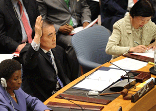 China's U.N. envoy votes to abstain from the Security Council resolution on Libya, March 17, 2011.