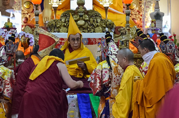 The Dalai Lama receives an offering during a long life prayer ceremony in Dharamsala, India, June 21, 2015.