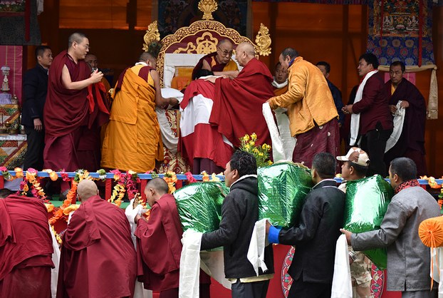 Buddhist followers offer gifts to the Dalai Lama after he delivered religious teachings in Bomdila, in India's Arunachal Pradesh state, April 5, 2017.