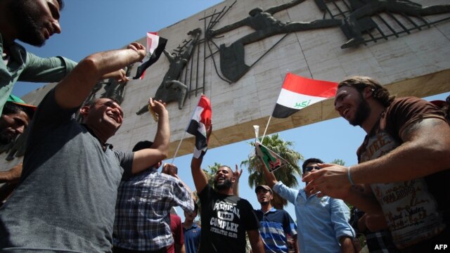 Iraqi demonstrators gather in the streets of Baghdad on August 14, shouting slogans in support of reforms proposed by Iraqi Prime Minister Haidar al-Abadi aimed at curbing corruption.