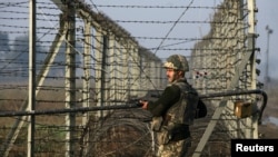 An Indian border guard patrols near the fenced frontier with Pakistan along the Line of Control in Kashmir (file photo).