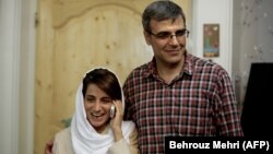 Nasrin Sotoudeh (left) speaks on the phone next to her husband, Reza Khandan, as they pose for a photo at their house in Tehran in September 2013.