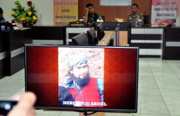 Indonesian police display an image of one of two Uyghur men they say were killed in Central Sulawesi this week, March 16, 2016.