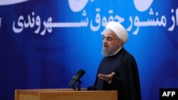 Iranian President Hassan Rohani gives a speech during a televised ceremony after he unveiled a landmark bill of rights in Tehran on December 19.