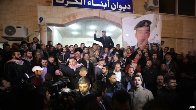 Supporters and family members of Jordanian pilot First Lieutenant Muath al-Kasasbeh gather following his reported killing in the Jordanian capital, Amman, late on February 3.