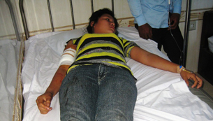 A worker injured in the shooting is treated at the Svay Rieng Provincial Hospital, Feb. 20, 2012.
