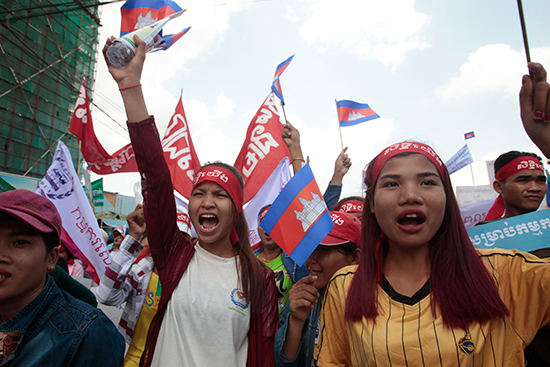 Garment workers protest for higher wages near Cambodia's National Assembly in Phnom Penh, May 1, 2017. As the government clamps down on opposition ahead of local elections scheduled for June, a Radio Free Asia journalist has fled the country upon learning of a warrant for his arrest. (AP/Heng Sinith)