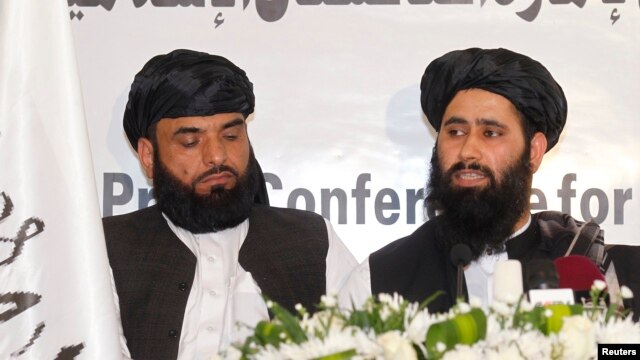 Muhammad Naeem (right), a spokesman for the Office of the Taliban of Afghanistan, speaks during the opening of the Taliban Afghanistan Political Office in Doha, Qatar, on June 18.