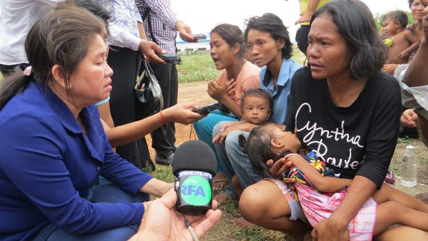Ke Sovannaroth (L), chairperson of the Cambodian parliament's social affairs commission, speaks with detainees at Posen Chey Vocational Training Center near Phnom Penh, July 7, 2015.