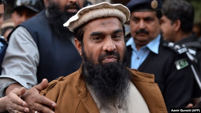 Pakistani security personnel escort Zaki-ur-Rehman Lakhvi as he leaves court after a hearing in Islamabad on January 1.