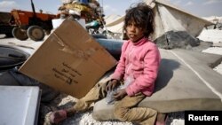 An internally displaced girl who fled Raqqa city sits inside a camp in Ain Issa, in Raqqa Governorate, on May 4.