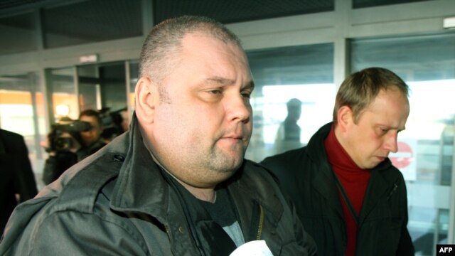 Russian citizen Yury Mel (left) is brought to the district court in Vilnius on March 14.