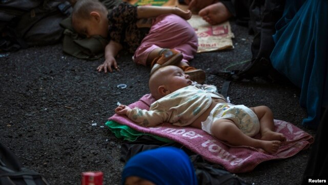 Children of Uyghurs from China's western region of Xinjiang rest inside a temporary shelter in Thailand.