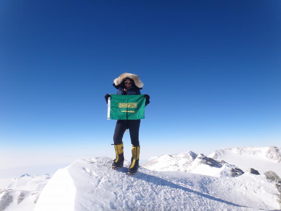 Raha Moharrak holds the Saudi Flag on Mount Everest as Saudi Arabia's first female and youngest Arab to reach the summit. With limited training facilities in Saudi Arabia, Moharrak taught herself to climb. In one year, she reached the peak of eight mounta