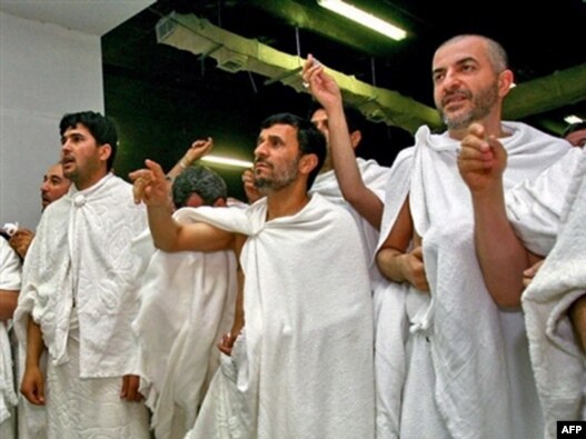 Iranian President Mahmud Ahmadinejad (center) throws stones at a column symbolizing the devil in Mecca.