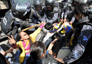 Nepalese riot police arrest Tibetan protesters in front of the Chinese Embassy in Kathmandu, March 10, 2012,