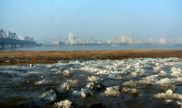 This undated file photo shows the China's northeastern border city of Dandong in the distance from the North Korean border town of Siniuju.