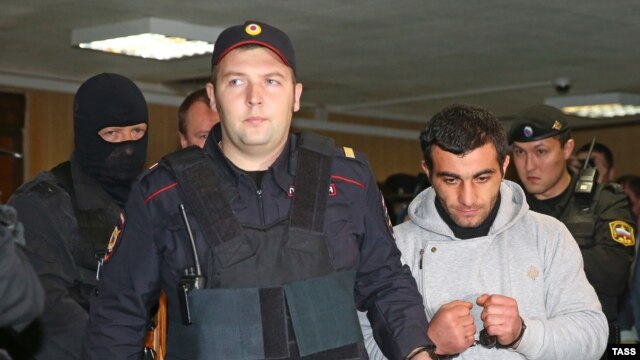 Orkhan Zeynalov (right) is escorted to a courtroom in Moscow on October 17.