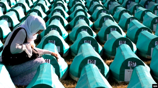 Bosnian Muslim women mourn over a casket at the Potocari Memorial Center during the burial in 2008 of 308 Bosnian Muslims killed by Bosnian Serb forces in Srebrenica.