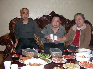 Hada (l) shares a meal with son Uiles (c) and wife Xinna (r) in this photo dated Dec. 10, 2010.