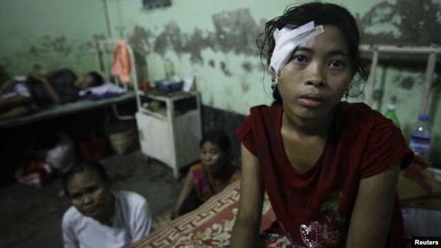 A victim of recent violence in Burma rests in hospital after being treated for a gunshot wound. 