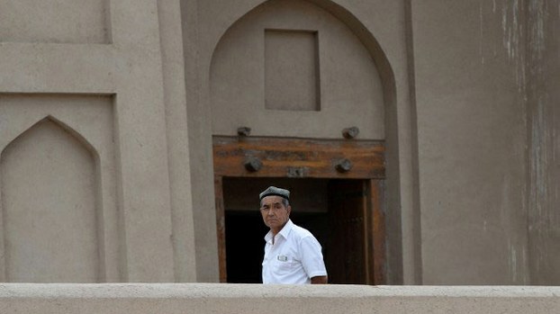 A Uyghur man stands outside a mosque in Turpan, Xinjiang,in a file photo.