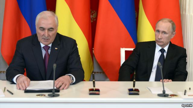 South Ossetian separatist leader Leonid Tibilov (left) addresses the media after talks with Russian President Vladimir Putin at the Kremlin in Moscow on March 18.
