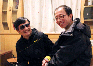This undated photo shows rights activist Hu Jia (R) sharing a light moment with Chen Guangcheng after his escape, at an undisclosed location in Beijing.