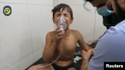 A still image from a video posted on social media said to be shot in Aleppo on September 6, 2016, shows a boy breathing with an oxygen mask inside a hospital, after a suspected chlorine gas attack.