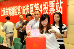 Staff at a Chinese company cast votes in local parliamentary elections in Shanghai, Sept. 14, 2011.
