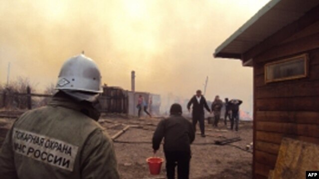 A firefighter and local residents battle a fire in a village in the Khakasia region in southeastern Siberia, earlier this week. 