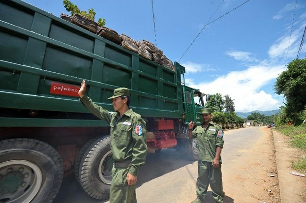 United Wa State Army soldiers stop a truck at a checkpoint in the Wa region of Shan state in a file photo.