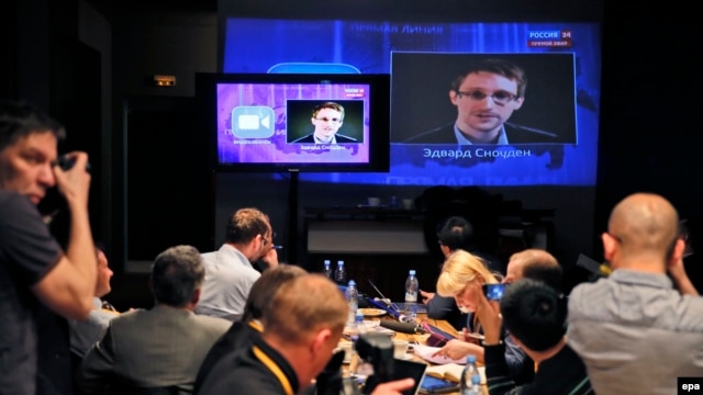 Journalists in Moscow listen to a speech and a question posed by former NSA contractor Edward Snowden at a media center during Russian President Vladimir Putin's nationwide phone-in program in April 2014.