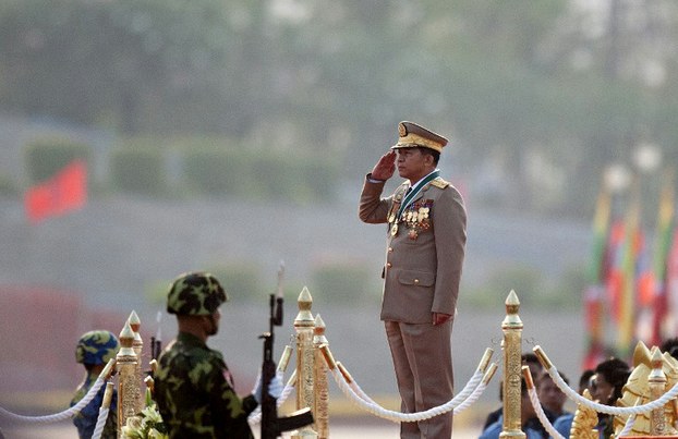 Myanmar's army chief, Senior General Min Aung Hlaing (C), salutes during a ceremony marking the 69th anniversary of Armed Forces Day in Myanmar's capital Naypyidaw, March 27, 2014.