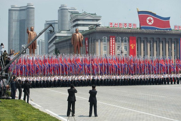 A North Korean military parade passes statues of former leaders in a file photo.