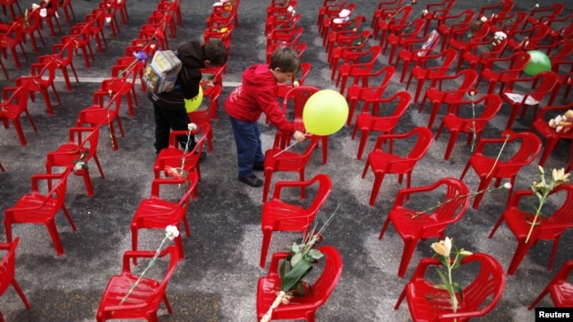 Children place flowers and balloons on chairs in Sarajevo in April 2012 to honor more than 11,000 children killed in the Bosnian war.