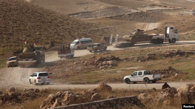 Vehicles belonging to Kurdish Peshmerga forces are seen in the town of Sinjar on November 12.