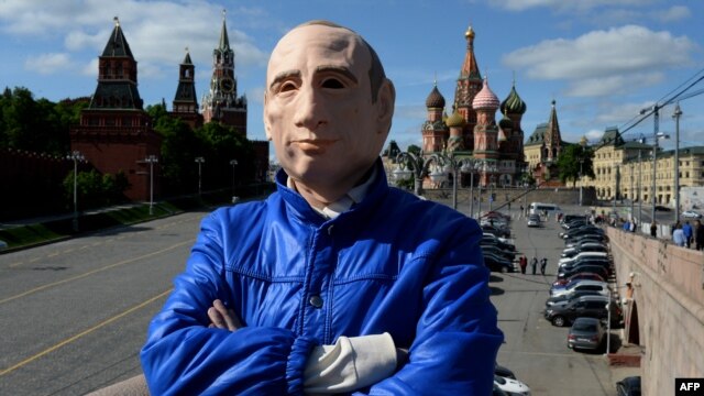 Russian activist Roman Roslovtsev, wearing a rubber mask depicting President Vladimir Putin, poses for a picture in central Moscow on May 12.