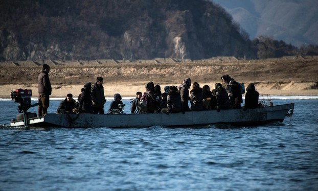 North Koreans ride a boat on the Yalu River near the North Korean town of Sinuiju, as seen from across the river from the Chinese border town of Dandong, Feb. 9, 2016.
