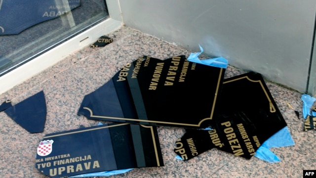 A sign with Serb Cyrillic script lies on the ground after being ripped off a wall by Croatian protesters in Vukovar on September 2.