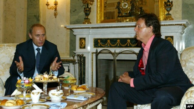 Russian President Vladimir Putin (left) speaks with Paul McCartney during their meeting at the Kremlin in Moscow in 2003.