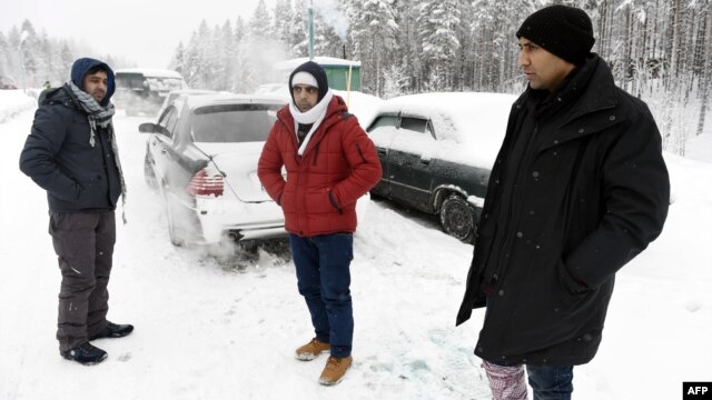Asylum seekers from Afghanistan and Pakistan wait for permission to cross the Arctic border into Finland in January.
