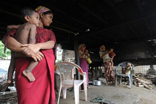 Muslim women hold their children at their house in Sittwe, June 6, 2012.