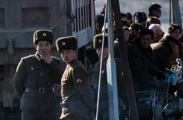 North Korean soldiers stand on a boat on the Yalu River near the border with China, Feb. 9, 2016.
