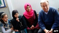 UN Secretary-General Antonio Guterres (right) talks to Syrian women and girls during a visit to the Zaatari refugee camp, which shelters some 80,000 Syrian refugees on the Jordanian border with war-ravaged Syria, on March 28.
