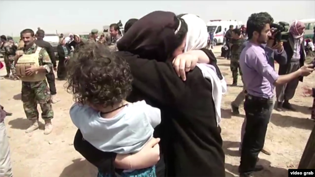 Yazidis receive aid in Kirkuk after they were released by Islamic State militants.